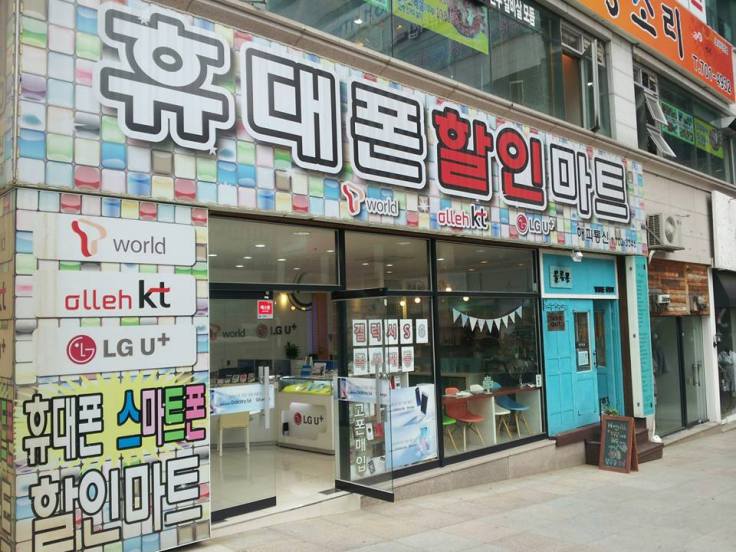 81. a "Take Out" coffee shop (the turquoise part) located in another cell phone shop, one street over from "Coffee & Mobile" in Jangsan, Busan.